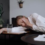 exhausted woman falling asleep on table