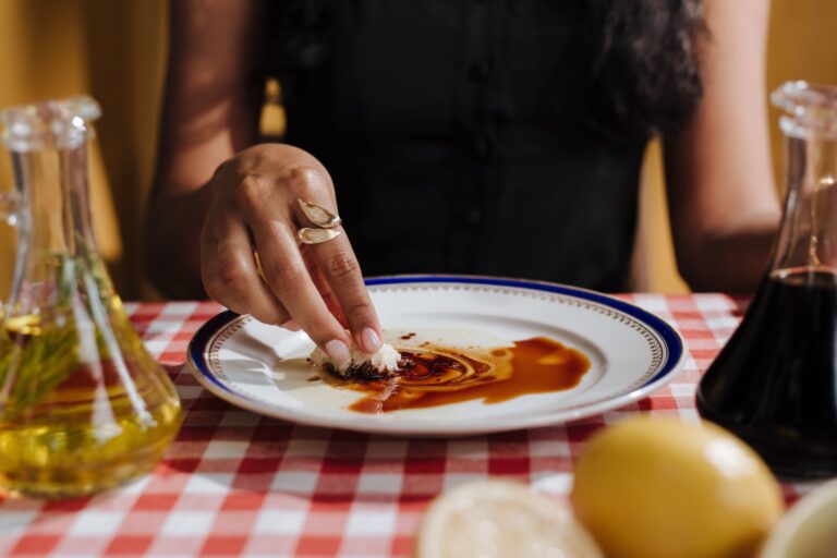 woman eating balsamic glaze with bread